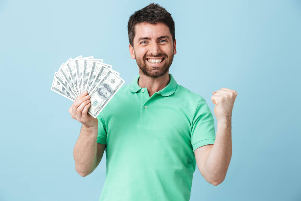 excited man with car title loan cash