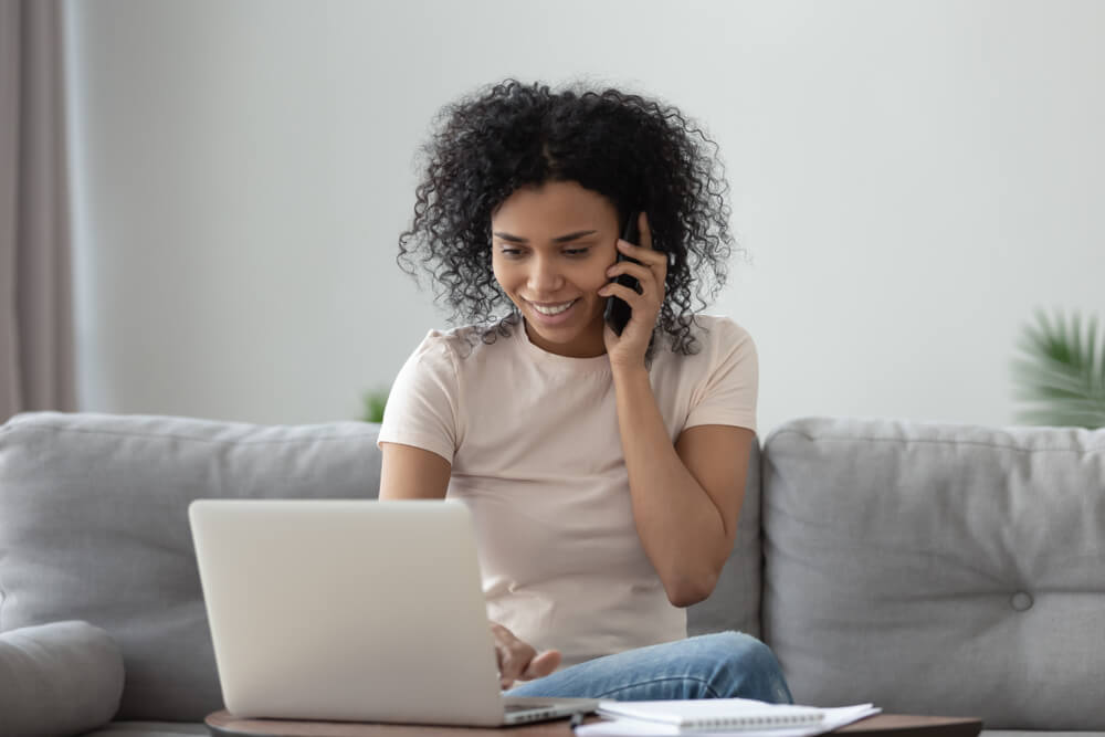 Woman on a couch talking to Delaware title loan representative