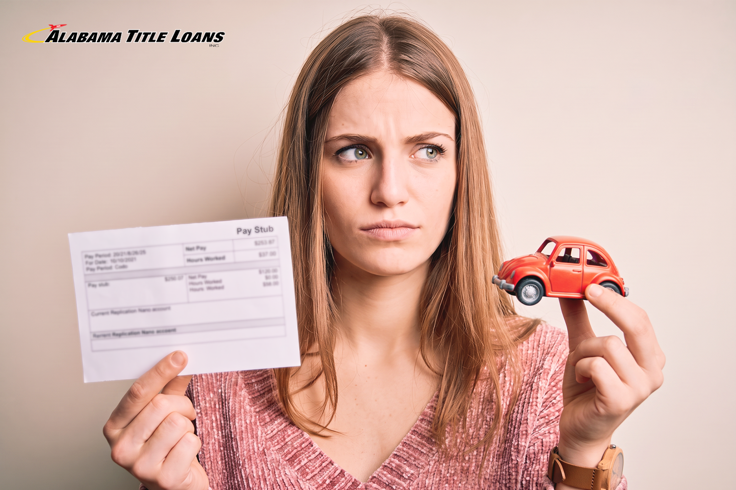 woman holding a car in one hand and a pay stub in the other