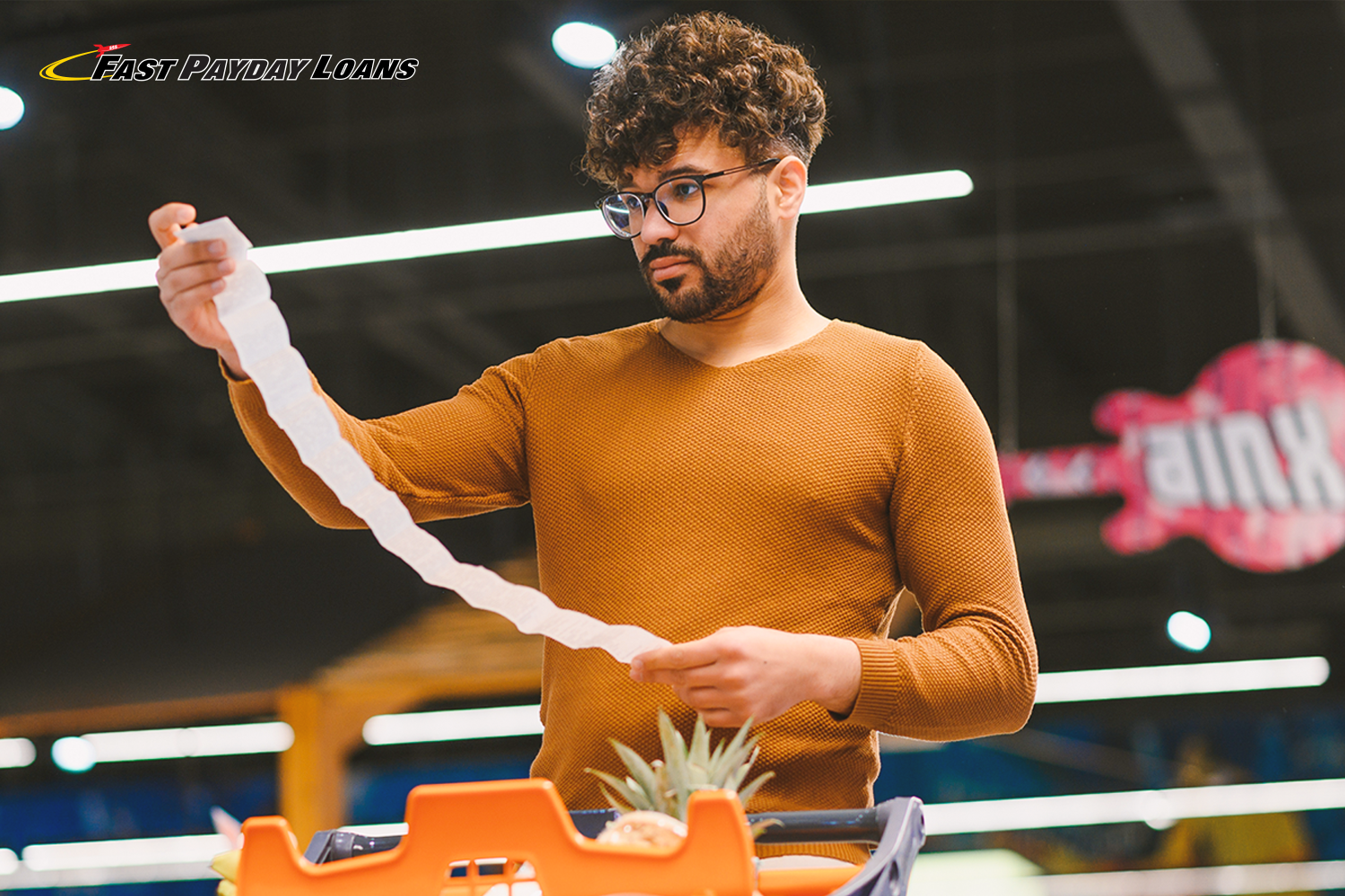 man looks at long grocery list that doesn't fit his food budget