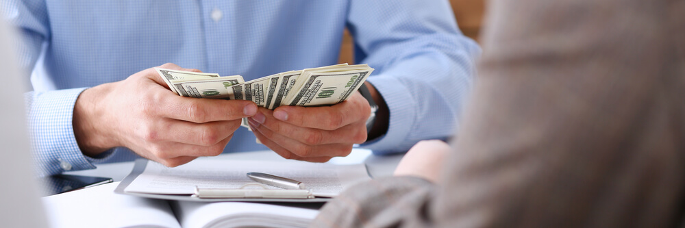 man counting installment loan cash