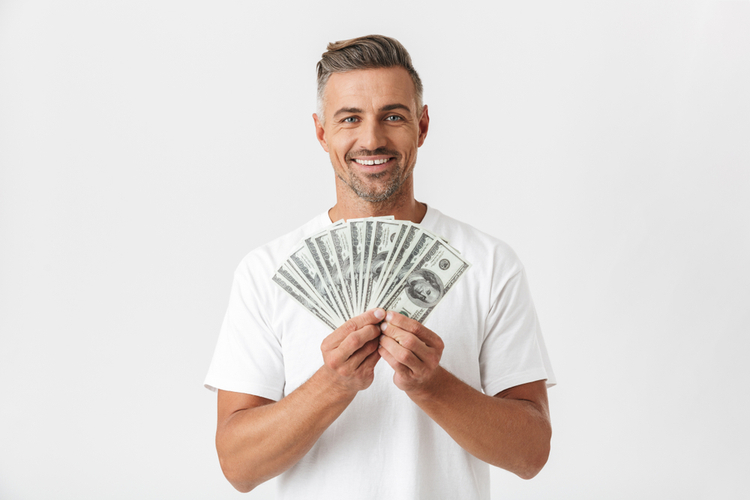 man holding title loan cash