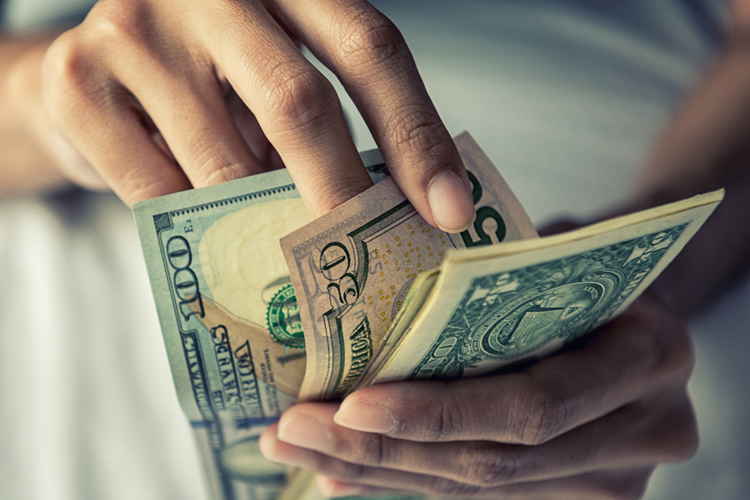 person counting money from cash loan