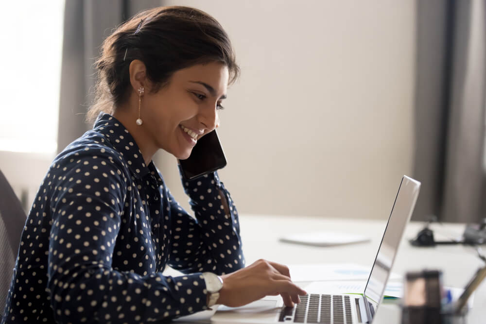 Happy woman looking up title loans online 