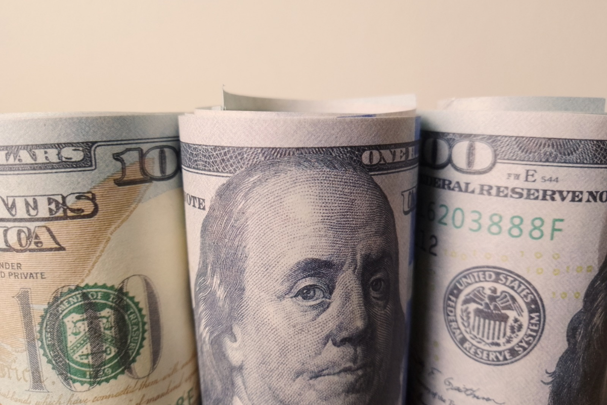 3 rolls of money with 100 dollar bills