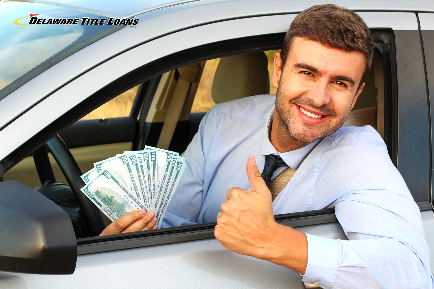 happy man holds title loan cash outside car window
