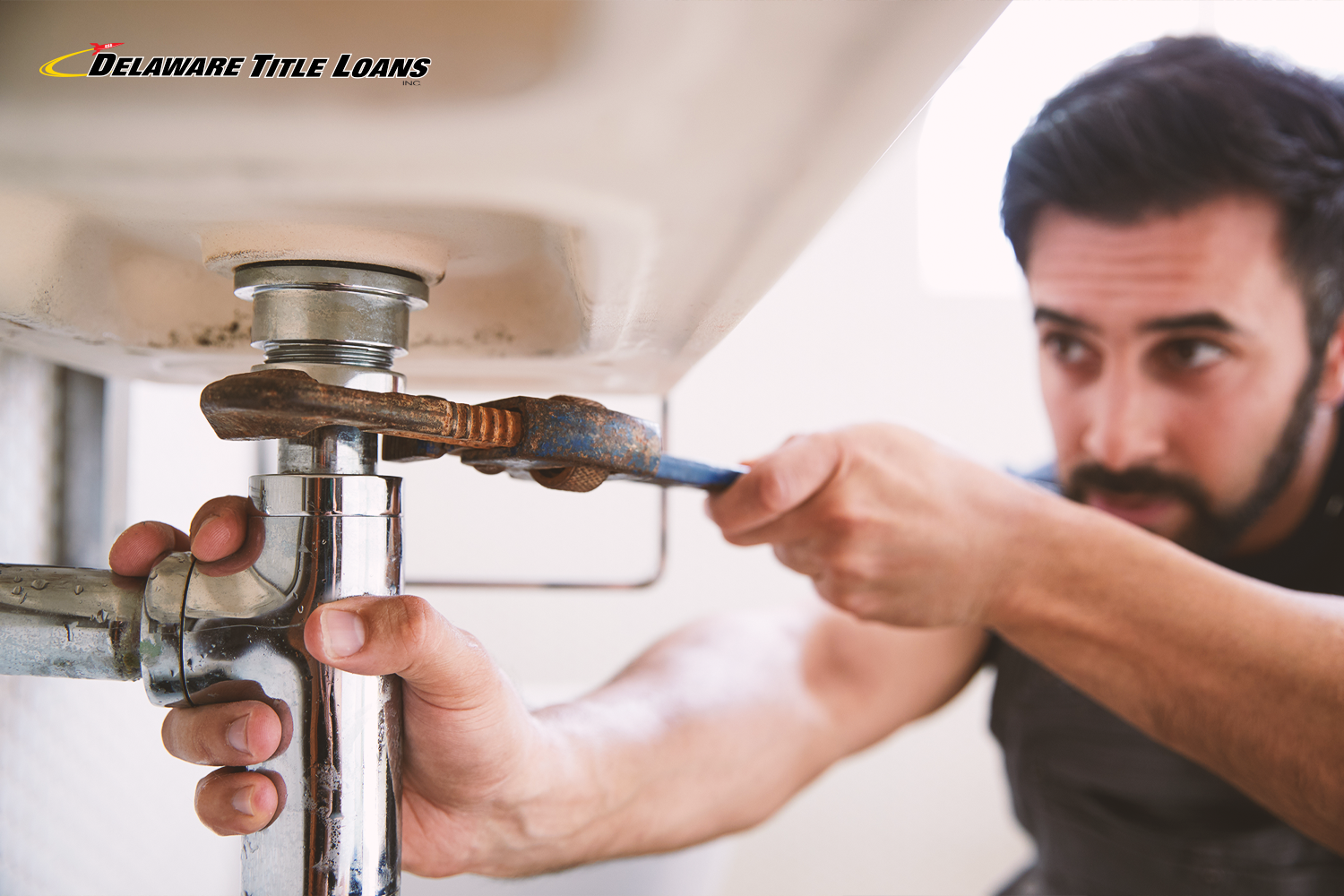 man fixes sink for spring home repairs