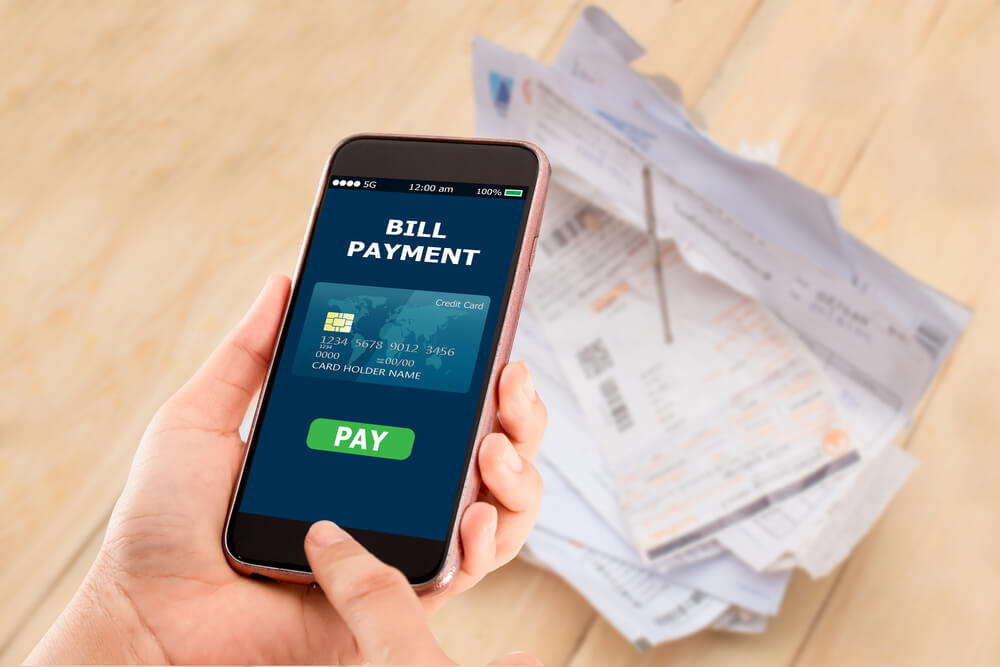 close up of person setting up auto bill payment on phone