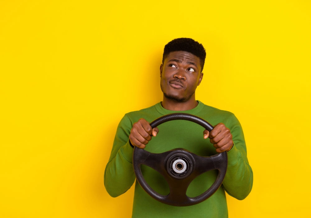 man with steering wheel for title loans