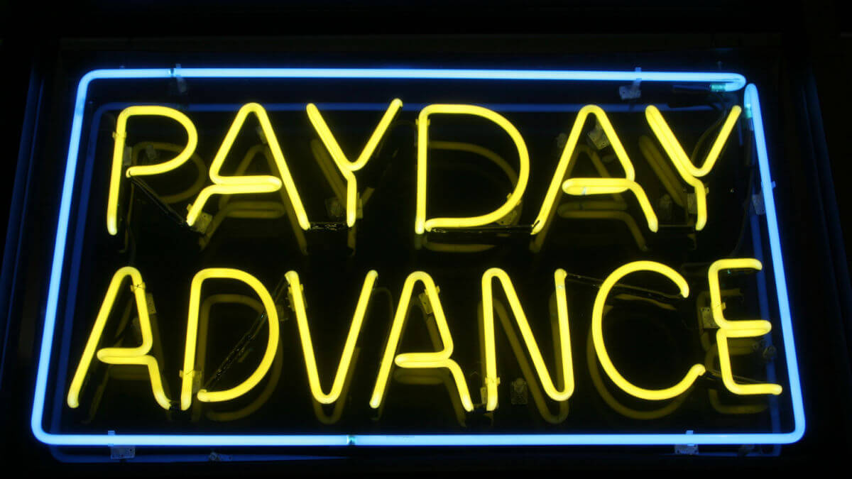 A neon sign that says PAYDAY ADVANCE.