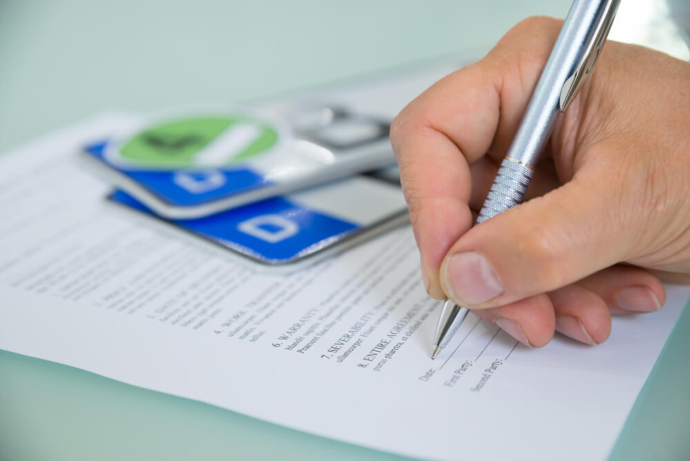 close up of person's hand applying for registration loan in AZ