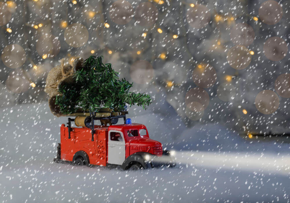 A toy truck in a snow storm searches for emergency Christmas help.