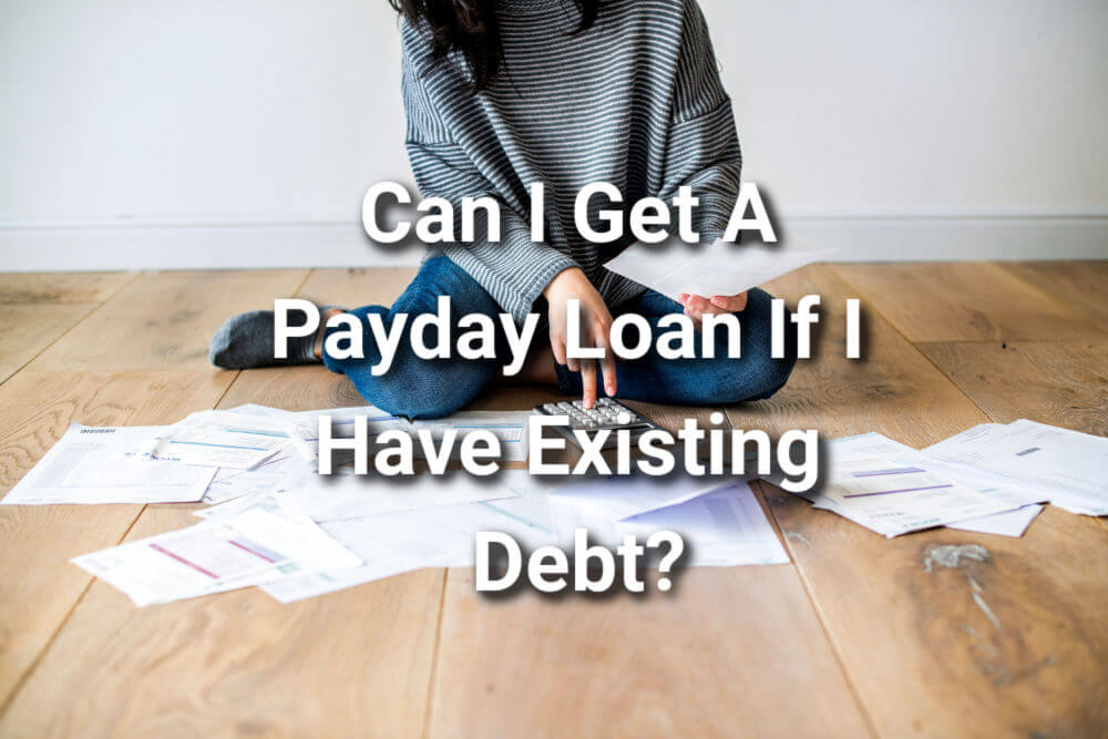 person sitting on ground working on finances with a payday loan