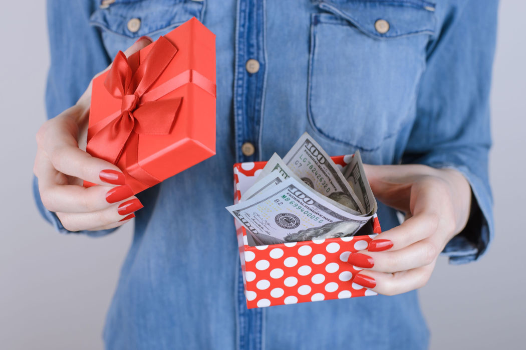 A white woman opens a box with money from receiving a holiday cash loan.