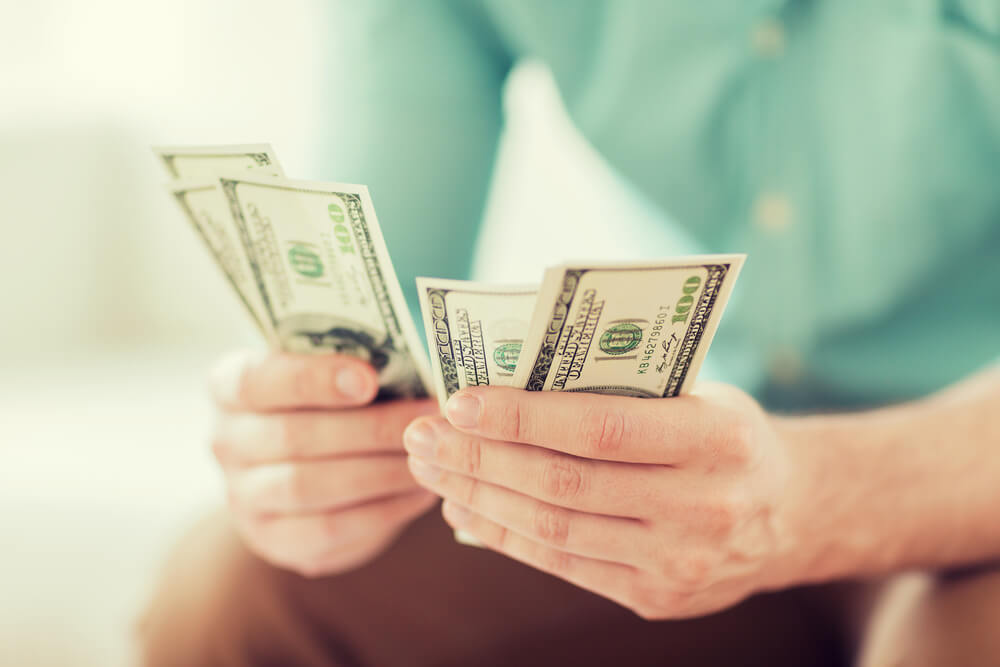 man counting payday loan money