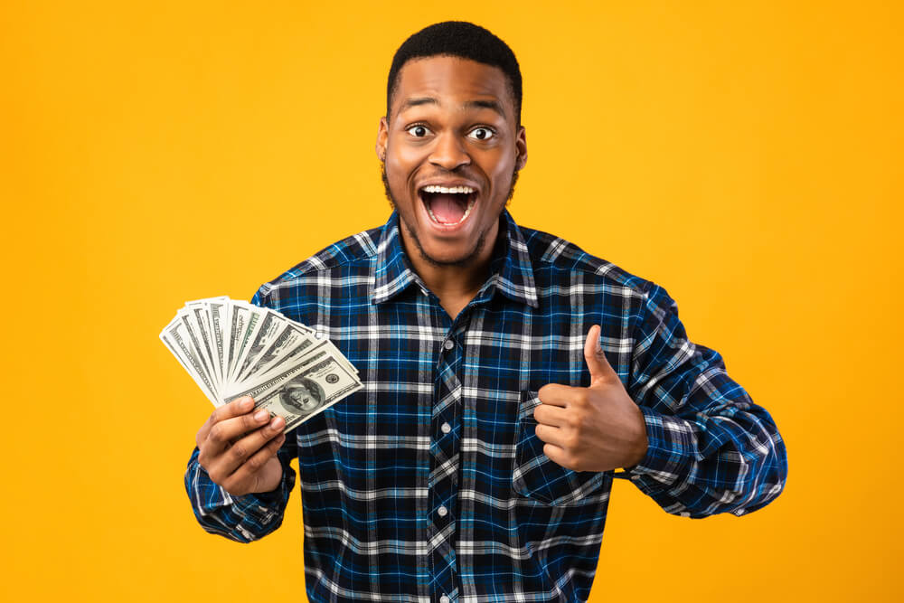 man excited from receiving a paycheck advance