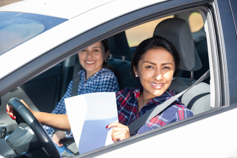 woman in car after receiving registration loans for emergency help 