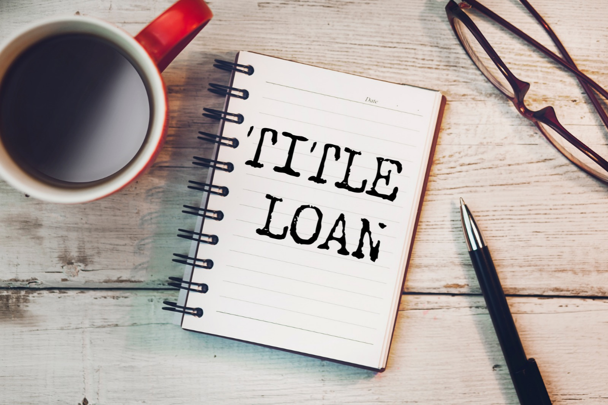 title loan written in book with a pen and coffee