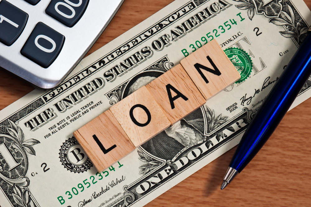 money and wood block spelling loan for title loan and payday loan