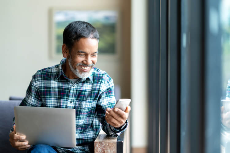 title loan get the facts happy man at computer with card