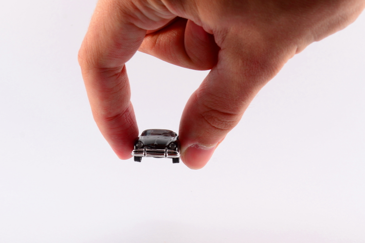 man holds toy car representing title loans