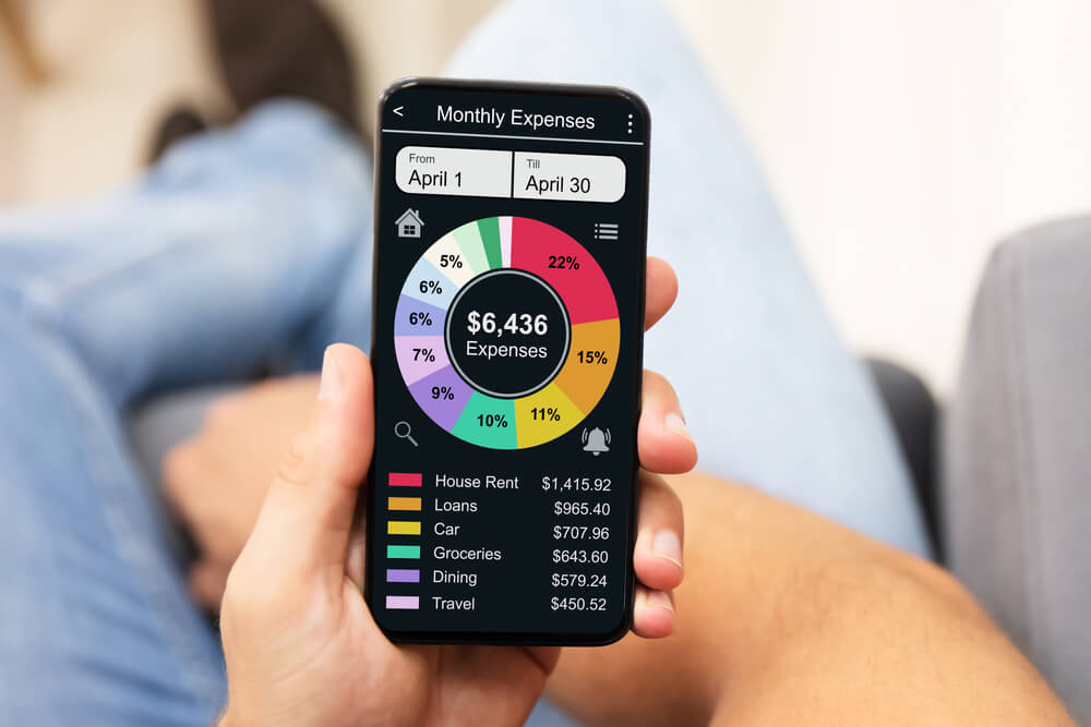 up close view of man using an expense tracker