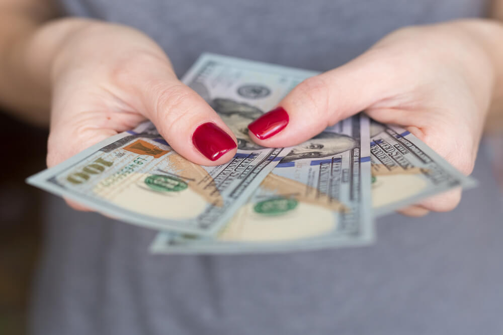 woman with payday loan dollars