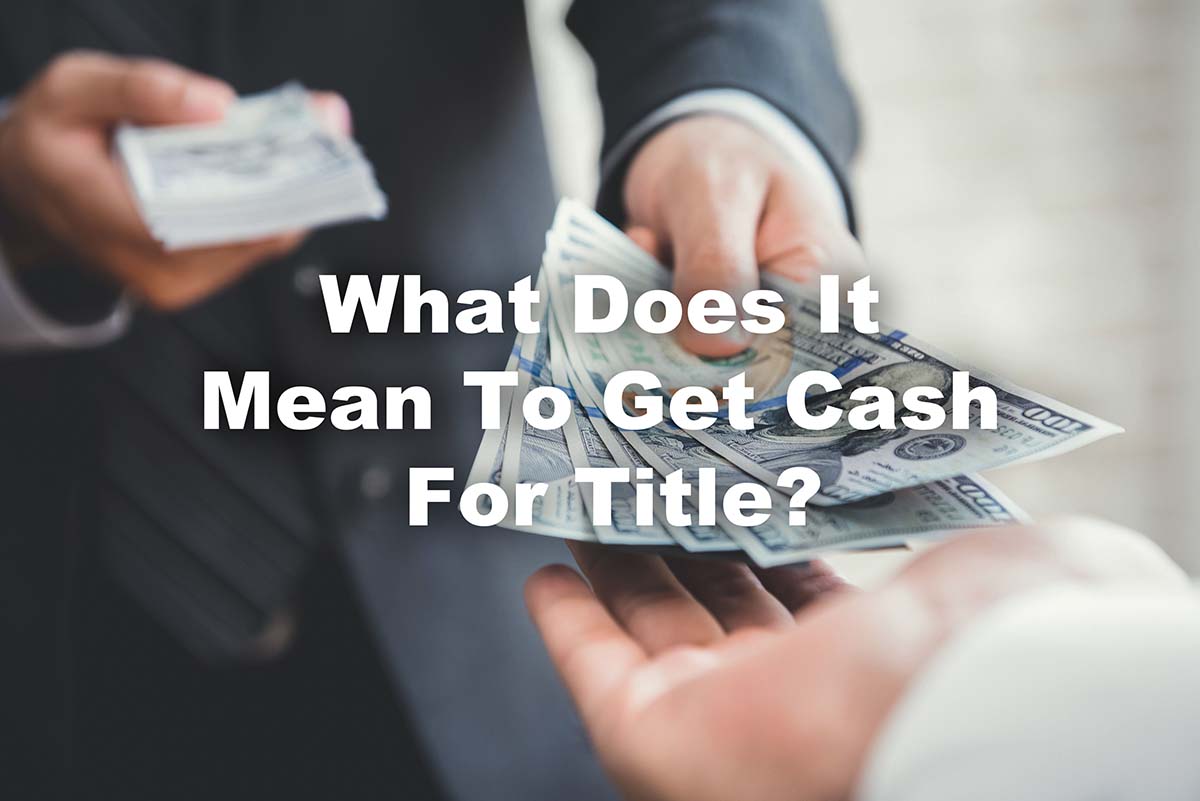 Close up of hand receiving title loan cash from representative with text What Does It Mean To Get Cash For Title?