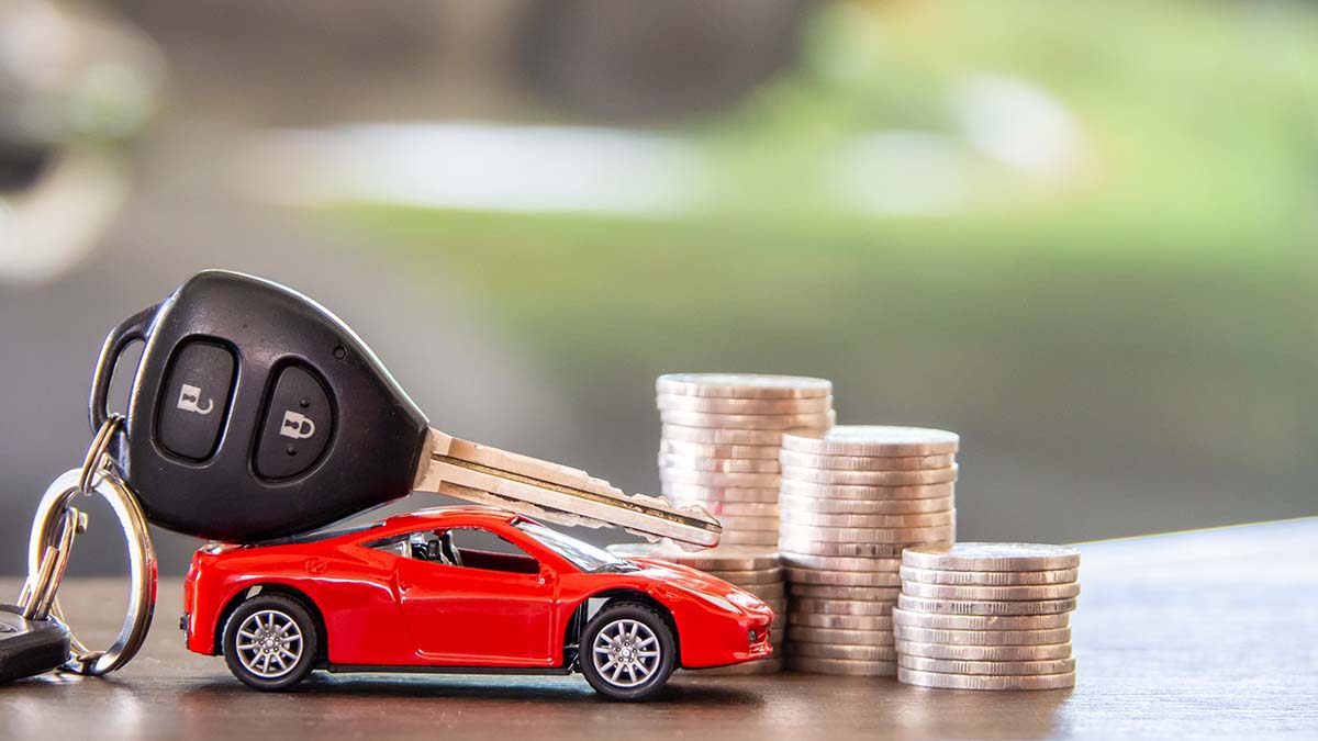 car key on toy car wiith coins for registration loan