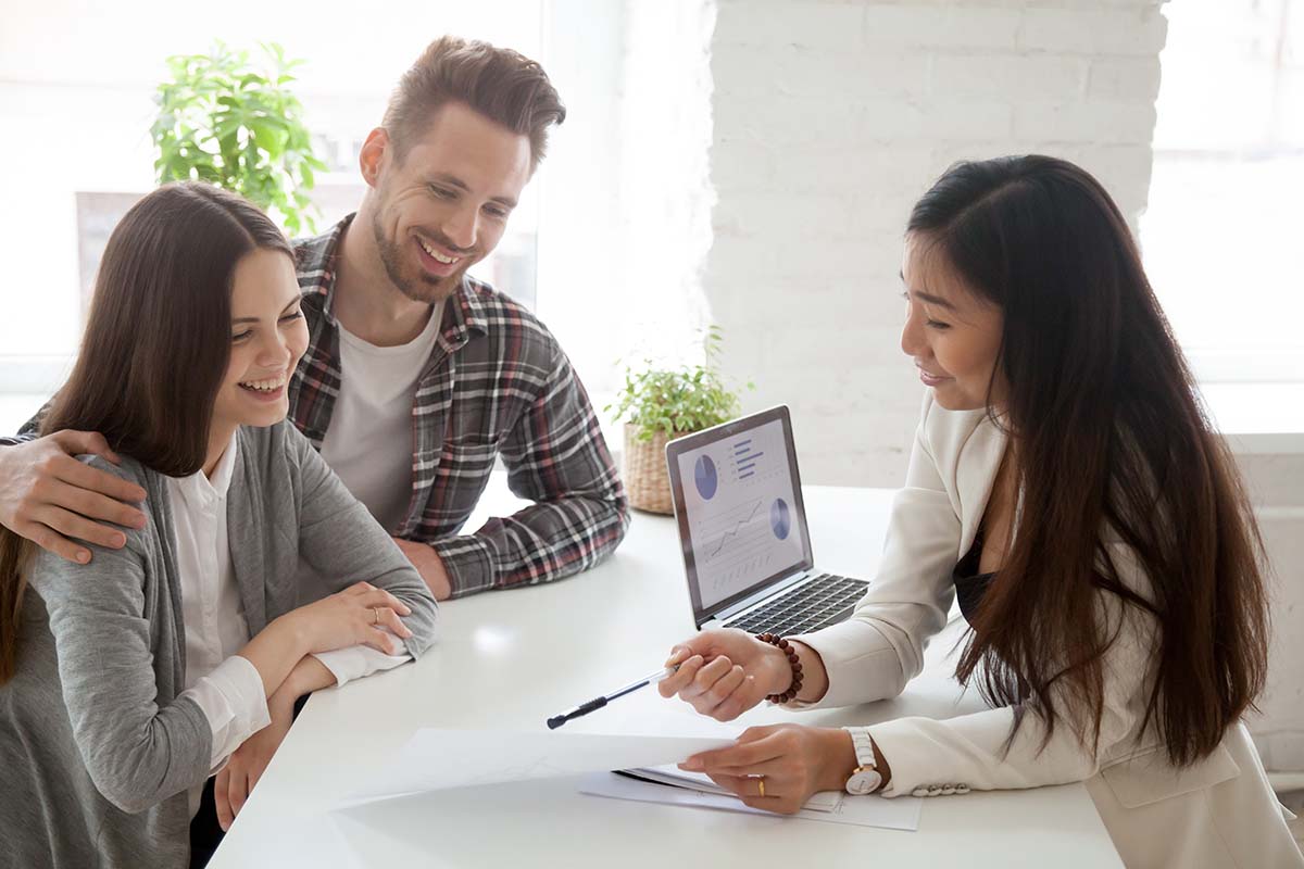 In the image, a couple with a lady discusses the benefits of a loan in Wisconsin, reflecting a conversation about financial assistance.