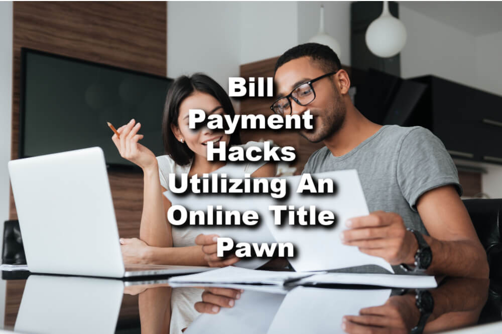 couple at computers pursuing an online title pawn with text bill payment hacks utilizing an online title pawn