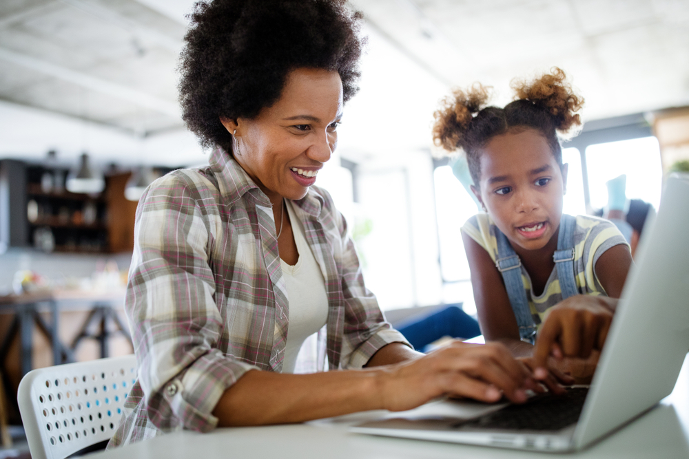 woman applying for title loan online while working from home with kids