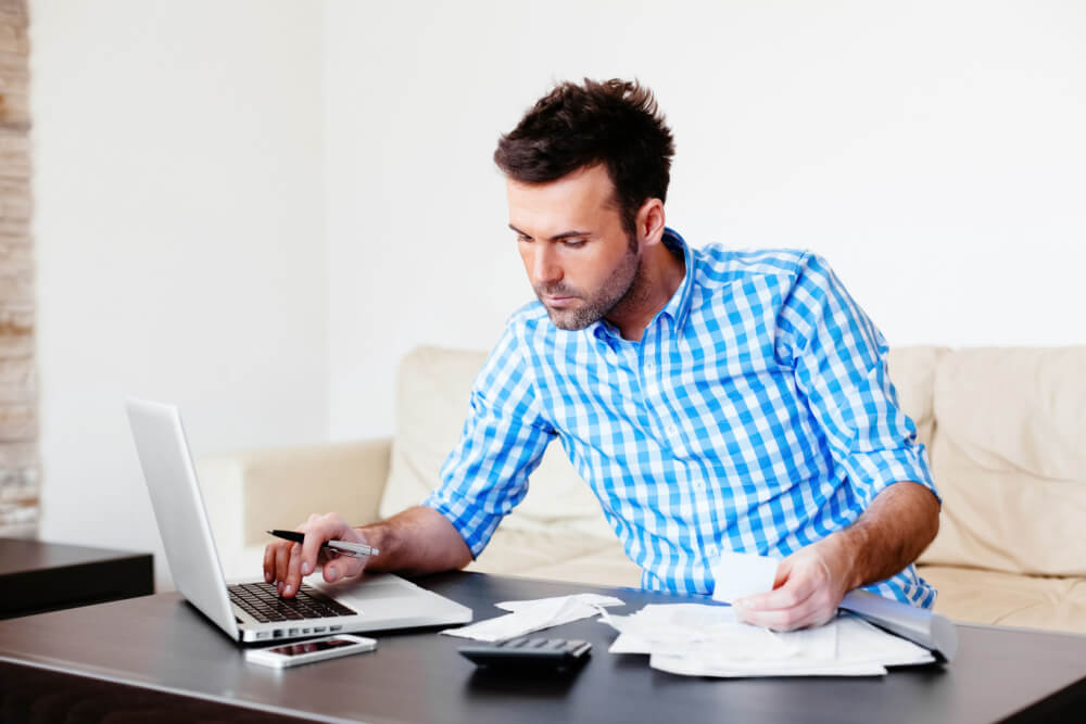 man at computer working on budget plan