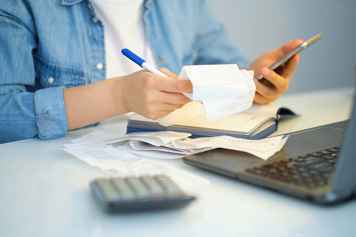 woman doing her bills on her phone