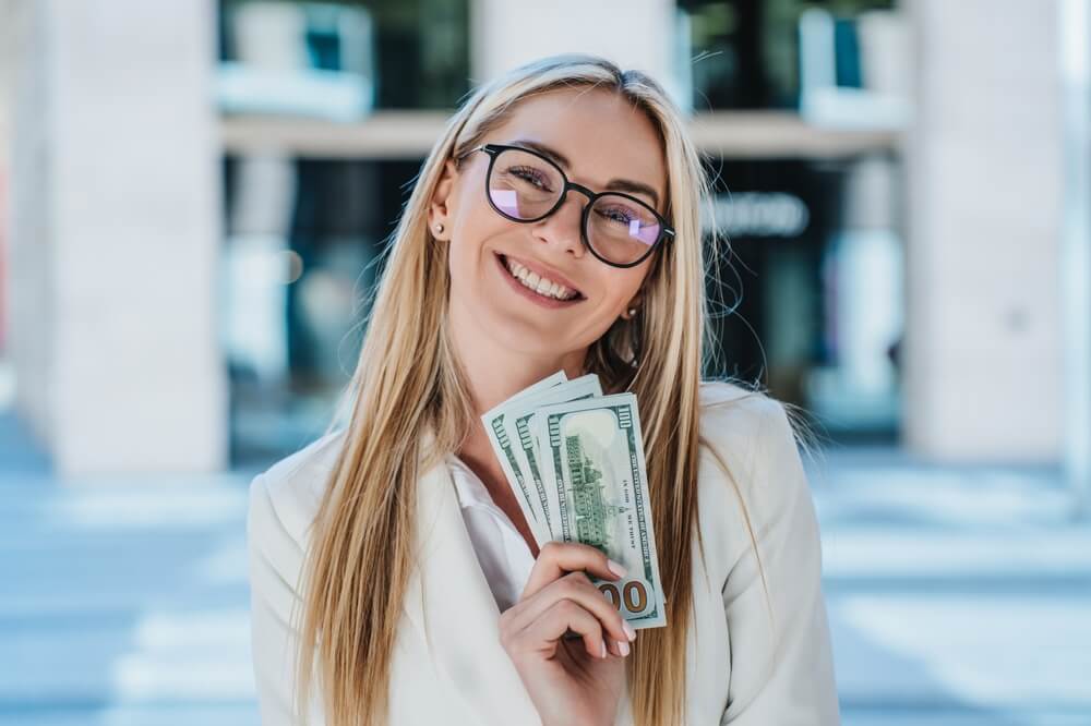 woman holding installment loan cash