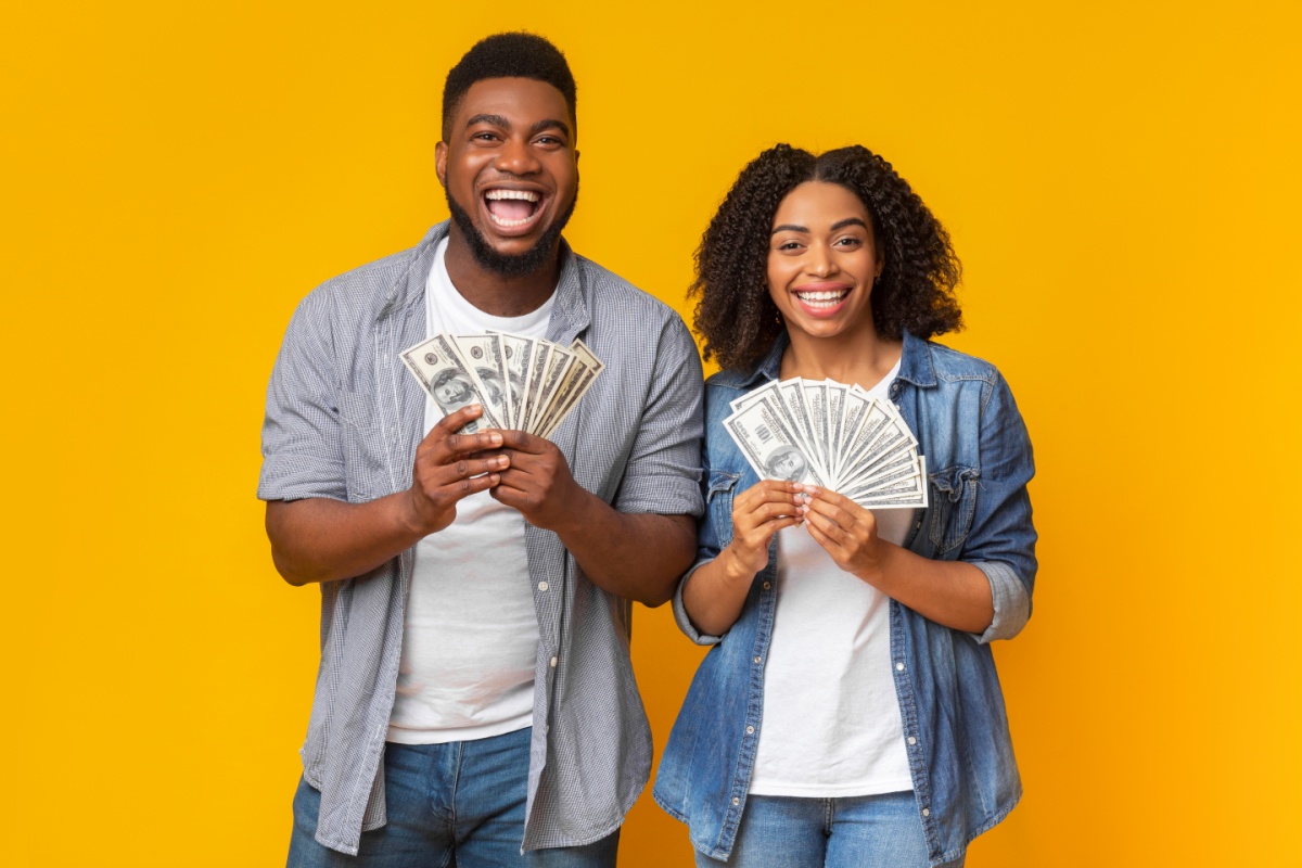 couple holding cash from title loan
