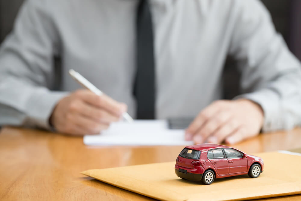 Man reviewing documents before applying for title loan online