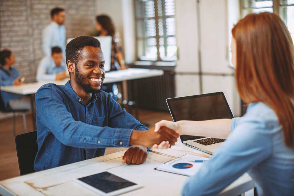 man meeting with payday loan representative and agreeing on terms