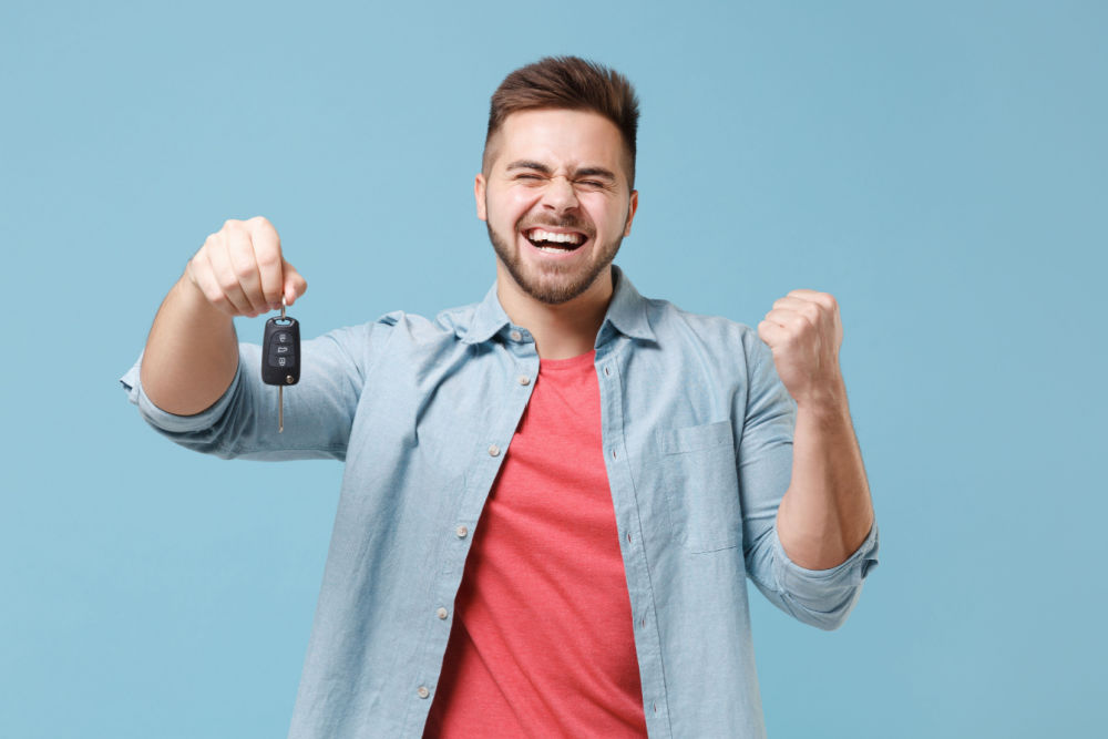 excited man with car for title loan Northport, AL