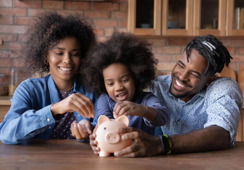 family putting money in piggy bank for help with financial health