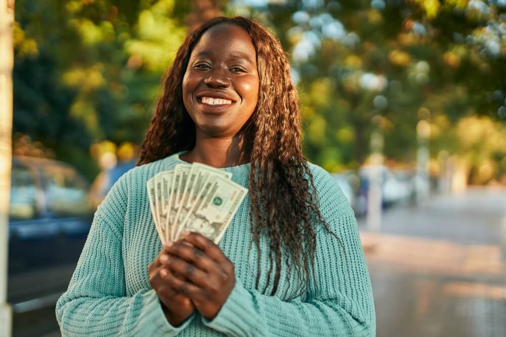 woman holding installment loan cash