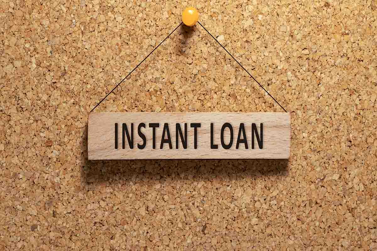  Receive an Instant Loan: A Text Carved in Wood, 'Instant Loan,' Pinned to a Brown Board