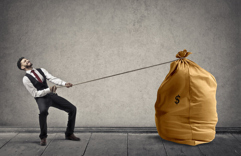 man trying to drag bag of cash