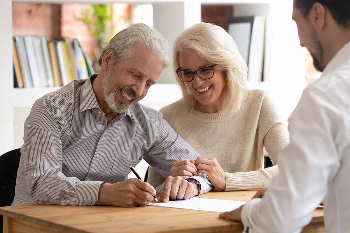 happy couple signing loan paperwork