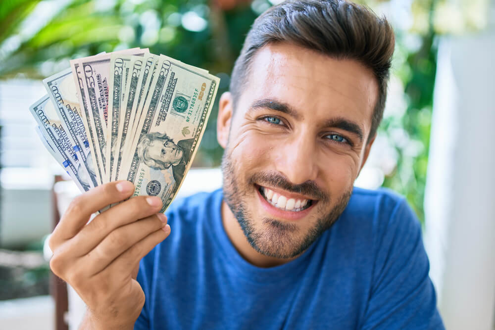 happy man holding florida payday advance cash