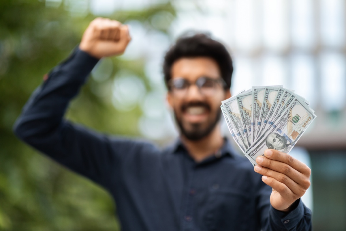 man celebrates holding Arizona emergency loan cash