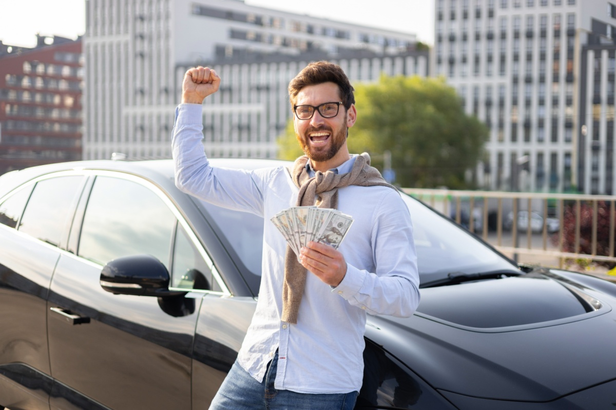 man celebrates that he can keep driving car after title pawn