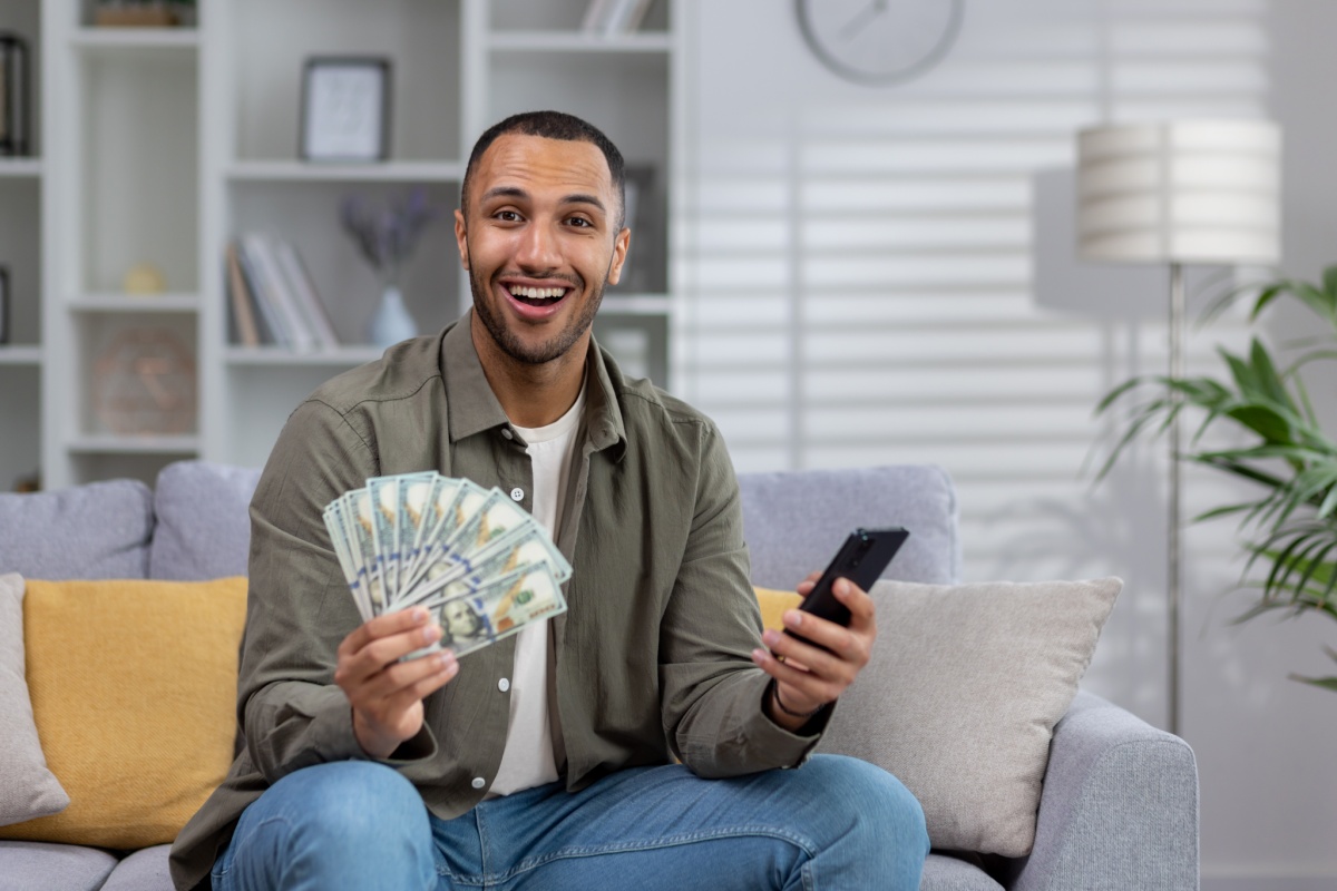 man celebrates with cash from a title pawn