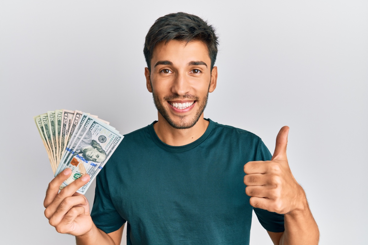 man happy holding payday loan cash