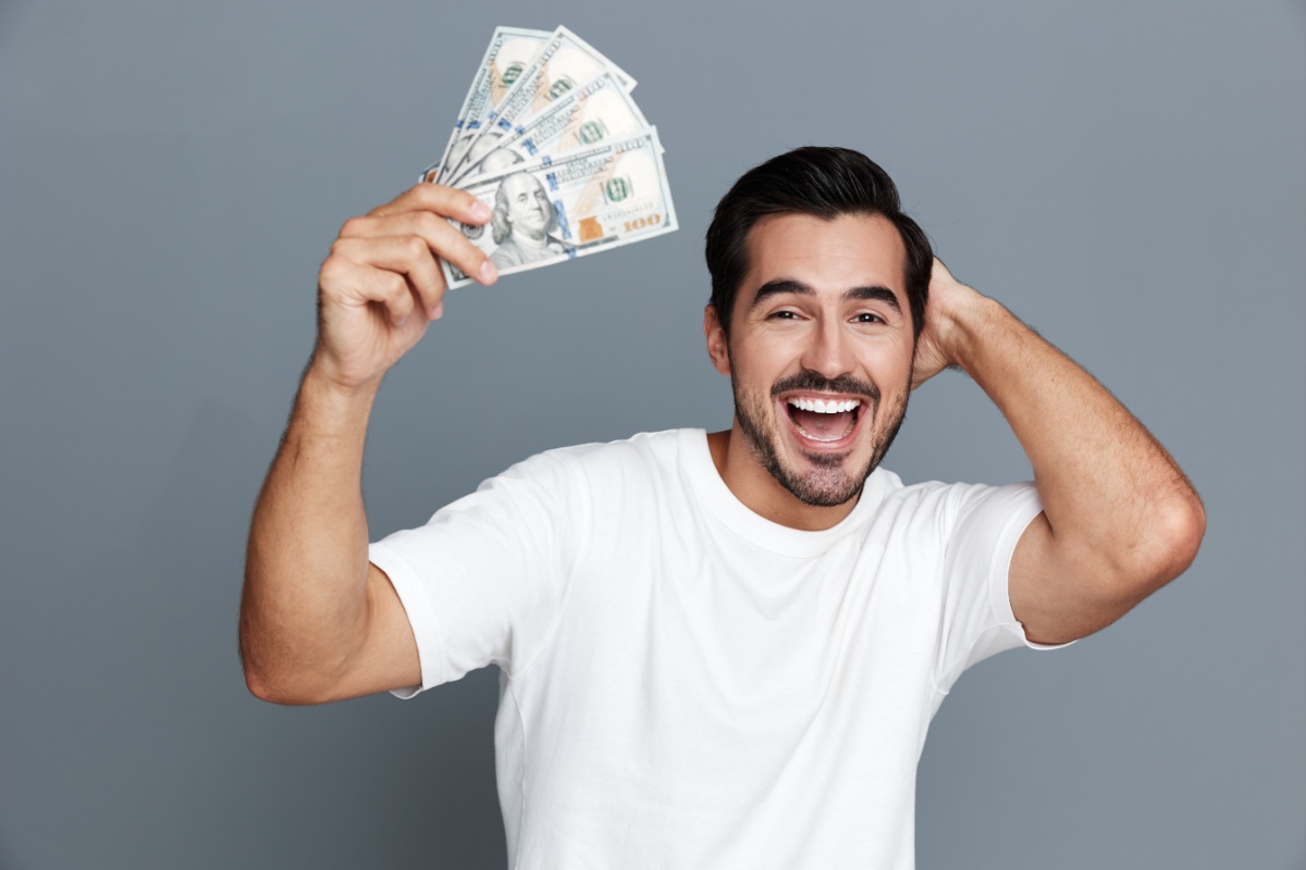 man holds cash from low-income payday loan